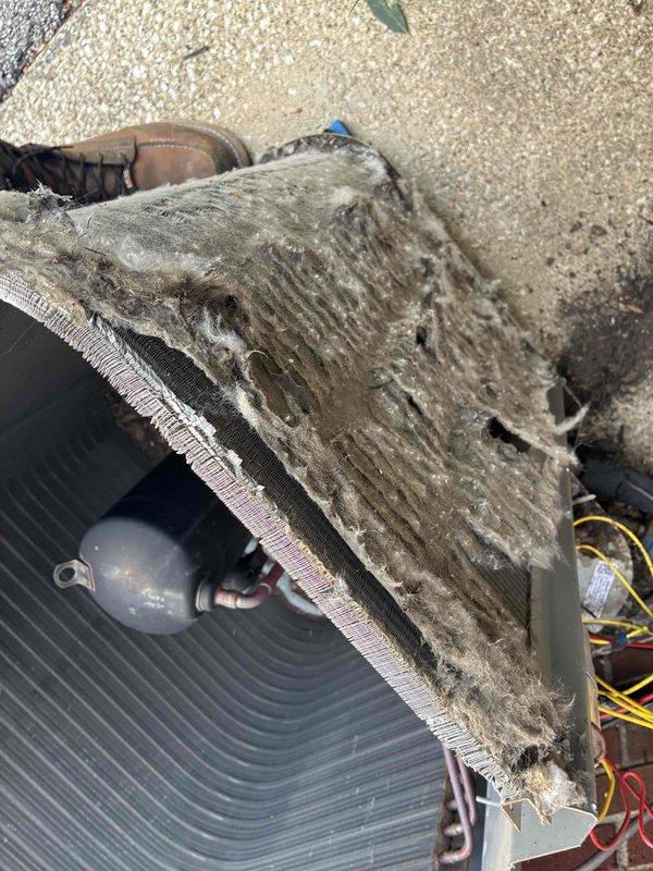 Responded to no cooling complaint on commercial air conditioning system. Upon arrival, found outdoor condenser unit operational but evaporator coil severely clogged with dirt, dust, and debris accumulation, restricting airflow and preventing proper heat transfer. Performed thorough coil cleaning to remove heavy contamination buildup from evaporator fins and surfaces. Restored system to proper operating condition with improved airflow and cooling capacity.
