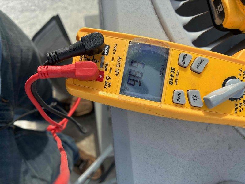 Responded to no cooling complaint on residential air conditioning system. Upon arrival, opened condensing unit access panel and performed diagnostic inspection of electrical components. Checked capacitor mounting and wire connections at contactor. Used Fluke T6-600 clamp meter to verify electrical readings, which showed 0.0 amperage draw, indicating compressor was not running. Identified failed contactor as root cause preventing compressor operation. Replaced defective contactor, verified all wire connections secure, and confirmed proper system operation with compressor drawing normal amperage. Unit restored to full cooling capacity.
