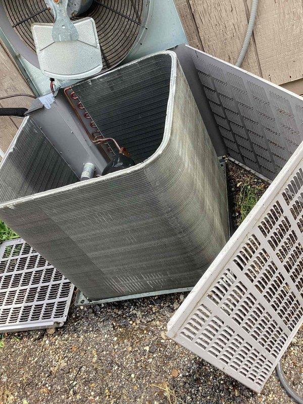 Responded to no cooling complaint at commercial office building. Accessed rooftop condenser unit and removed protective grille to inspect internal components. Found condenser coils heavily soiled with debris accumulation restricting airflow. Cleaned condenser coils, inspected refrigerant lines showing normal oxidation, and verified fan motor operation. Accessed interior mechanical cabinet and inspected refrigerant piping connections, ductwork, and associated components for leaks or damage. All connections secure with no refrigerant leaks detected. Reassembled equipment, restored power, and confirmed unit operating properly with adequate cooling to occupied space.