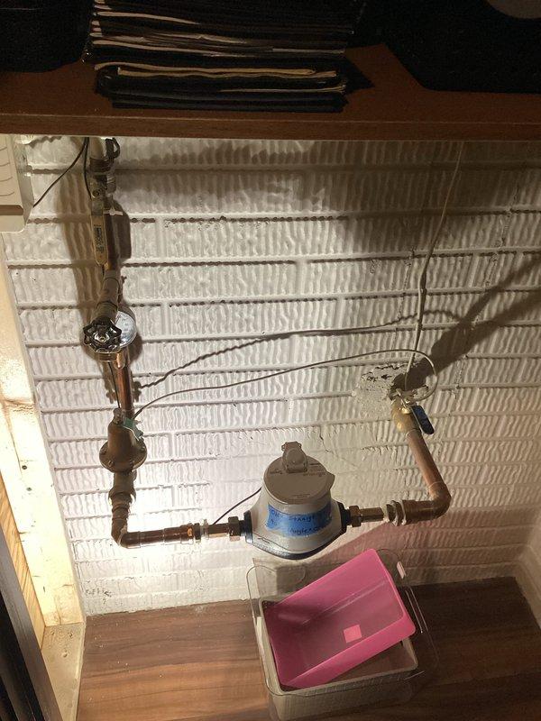 Performed site assessment for automatic water shut-off valve installation. Inspected existing plumbing infrastructure beneath kitchen sink area, documenting current water supply line configuration with pressure regulator and copper piping connections. Evaluated mechanical room layout and main water line access points to determine optimal placement for automated shut-off valve system. Photographed existing plumbing setup including supply lines, pressure regulation equipment, and available installation space. Provided customer with detailed estimate for automatic shut-off valve installation based on current plumbing configuration and accessibility requirements.