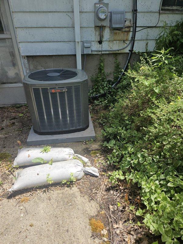 Responded to service call for 3-year-old Trane air conditioning unit that was not producing cold air and subsequently shut down. Rescheduled appointment to morning time slot to accommodate proper diagnostic and repair work. Upon arrival, inspected outdoor condensing unit and refrigerant line connections, noting R22/R410A compatible system with 70 piston configuration at evaporator coil entry point.