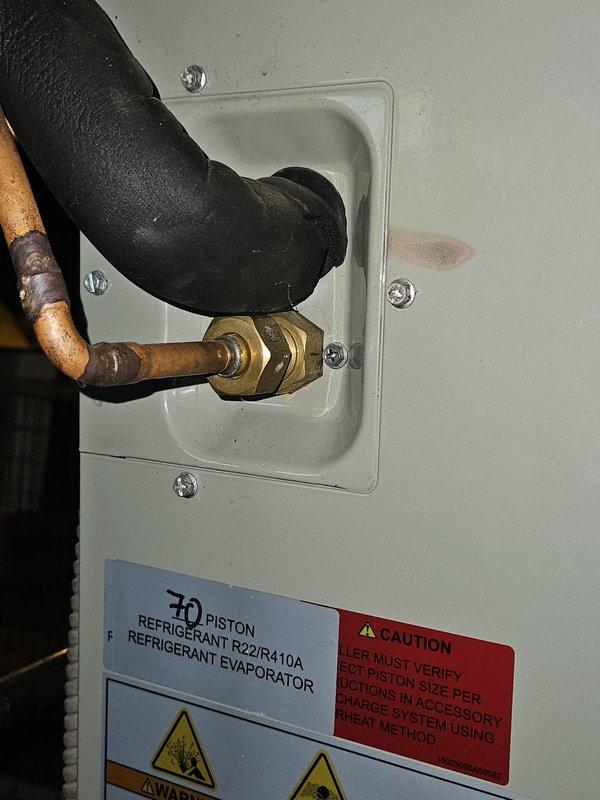 Responded to service call for 3-year-old Trane air conditioning unit that was not producing cold air and subsequently shut down. Rescheduled appointment to morning time slot to accommodate proper diagnostic and repair work. Upon arrival, inspected outdoor condensing unit and refrigerant line connections, noting R22/R410A compatible system with 70 piston configuration at evaporator coil entry point.