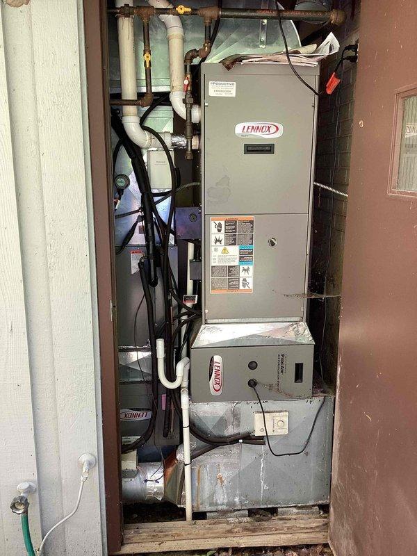 Completed comprehensive cooling maintenance and tune-up on 15-year-old Lennox air conditioning system. Performed full system inspection of outdoor condensing unit and indoor air handler, checking refrigerant levels, electrical connections, and overall operational performance. Addressed customer concerns regarding dehumidifier performance and humidity control issues, including investigation of dehumidifier interaction with AC system cycling. Inspected condenser coils for debris accumulation and verified proper airflow through outdoor unit despite vegetation growth around base. Evaluated indoor equipment including furnace/air handler unit, checked condensate drain lines, and verified proper operation of all system components. System confirmed operational and functioning properly at time of service completion.