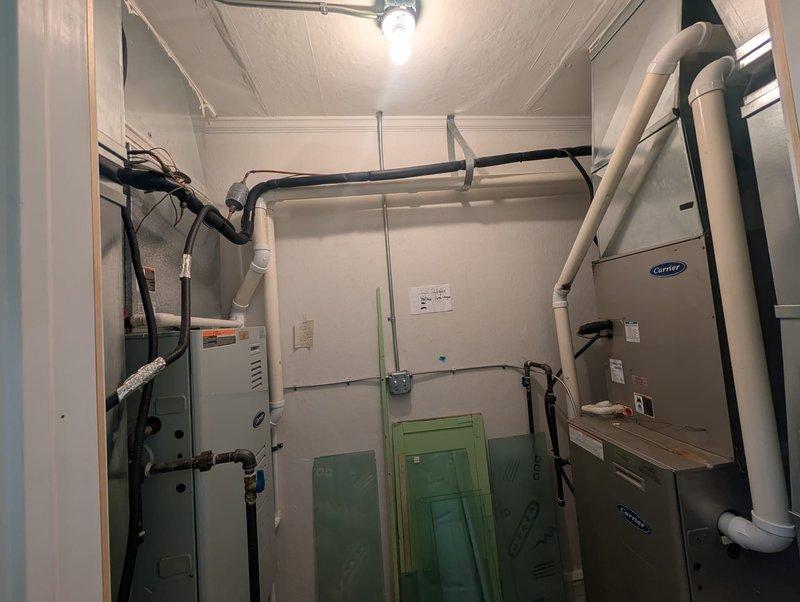 Responded to no cooling complaint for second floor A/C system. Inspected outdoor condenser unit and indoor air handler equipment. Verified condenser fan operation and checked electrical connections at outdoor disconnect panels. Assessed indoor mechanical room components including Carrier air handler, ductwork distribution, and associated refrigerant line sets. System operational after inspection with proper airflow restored to second floor zones.