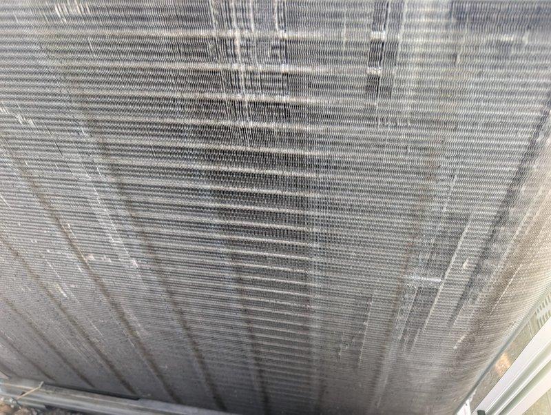 Performed comprehensive tune-up and cleaning service on multiple rooftop air conditioning systems. Thoroughly cleaned heavily soiled evaporator coils showing significant dust and debris accumulation with visible dark streaking and contamination throughout fin surfaces. Cleaned exterior condenser unit coils exhibiting substantial dirt buildup and darkened fin sections. Documented filter sizes for all units as requested and completed full system inspection to ensure proper operation of all air conditioning equipment.