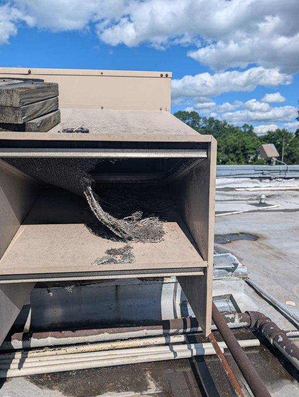 Responded to no cooling call on commercial rooftop unit RTU #6 serving lanes 1-15. Found unit with heavily contaminated filter compartment containing excessive accumulation of lint, dust, and fibrous debris restricting airflow. Removed debris, cleaned filter housing, restored proper system operation, and verified unit cooling performance.