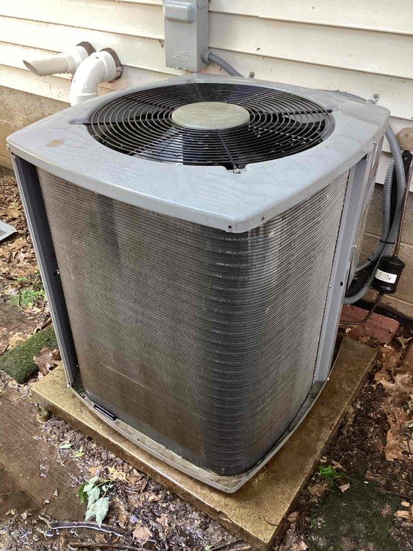 Completed maintenance tune-up on 12-year-old residential air conditioning system. Performed comprehensive inspection of outdoor condenser unit, verified proper operation of compressor and fan motor, and documented system temperatures. Evaporator coil exhibited normal ice formation during operation with measured temperature of 111.0°F at time of testing, indicating adequate refrigerant charge and airflow. Unit operating within manufacturer specifications with no immediate repairs required.