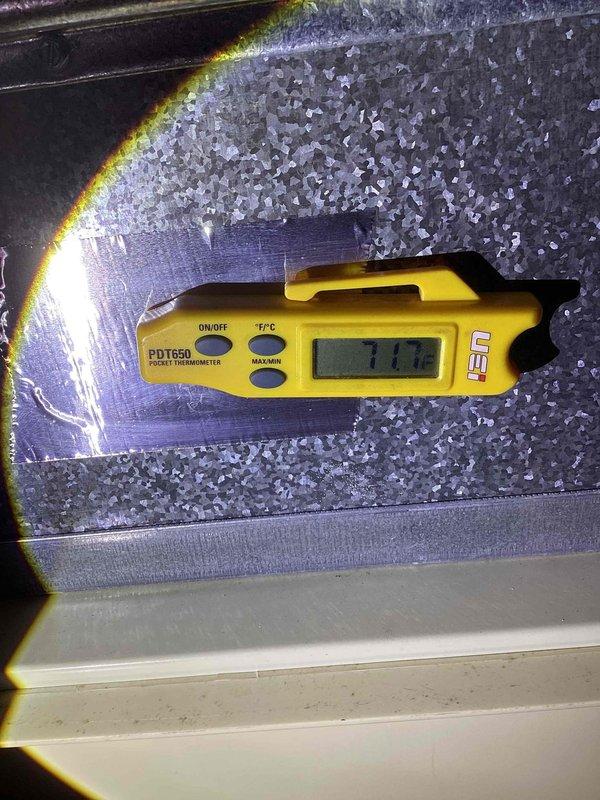 Completed maintenance tune-up on 12-year-old residential air conditioning system. Performed comprehensive inspection of outdoor condenser unit, verified proper operation of compressor and fan motor, and documented system temperatures. Evaporator coil exhibited normal ice formation during operation with measured temperature of 111.0°F at time of testing, indicating adequate refrigerant charge and airflow. Unit operating within manufacturer specifications with no immediate repairs required.