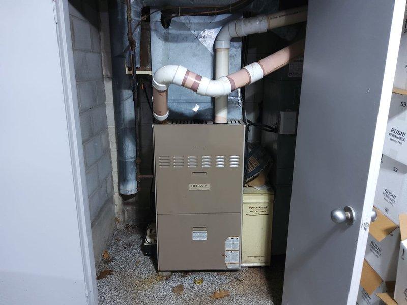 Completed comprehensive estimate for full HVAC system replacement in residential mechanical room. Assessed existing furnace unit, ductwork configuration, and condensate drainage system including PVC piping network with multiple connections and joints. Documented current equipment condition, spatial constraints in utility area, and recommended complete system upgrade to improve efficiency and reliability.
