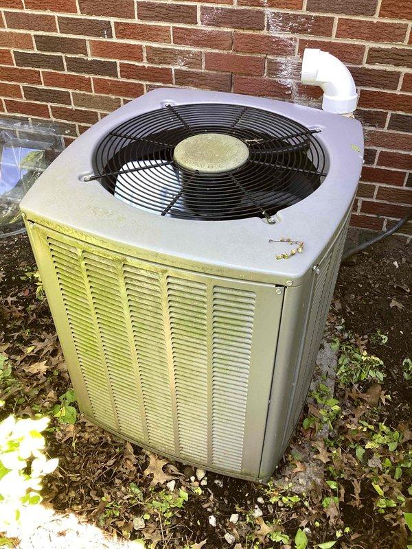 Completed comprehensive preventive maintenance on a 4-year-old residential air conditioning system. Performed full system inspection of outdoor condenser unit, including visual assessment of cabinet condition, fan assembly, and motor components. Cleaned condenser coils to remove environmental buildup and debris accumulation from fins. Verified proper operation of condenser fan motor and checked fan blade integrity and protective grille security. Inspected refrigerant line connections and condensate drain system, noting white PVC discharge line in proper working condition. Checked unit mounting and leveling on concrete pad. Cleared vegetation and debris from around unit perimeter to ensure adequate airflow and prevent future obstruction. System operating within normal parameters with no deficiencies noted. Unit maintained proper clearances and showed appropriate wear for age. All components functioning as designed with no immediate service needs identified.