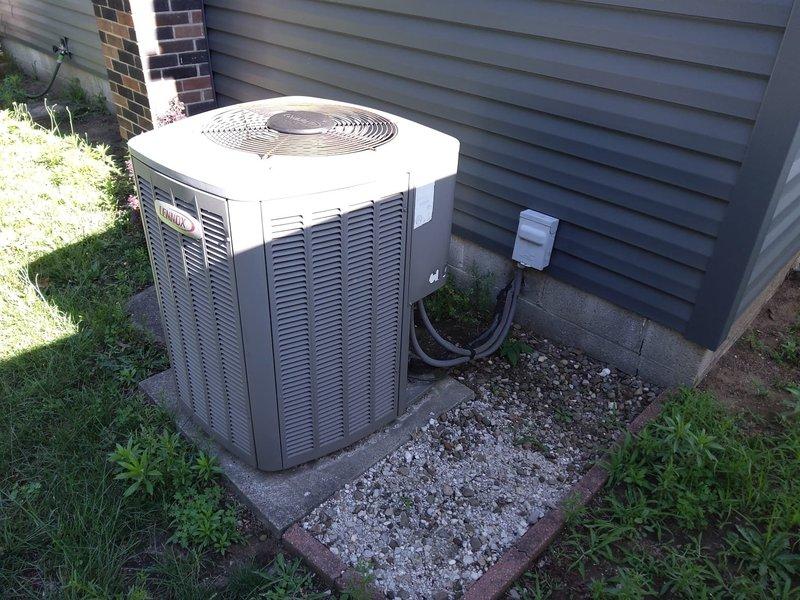 Completed full HVAC system retrofit including removal of existing equipment and installation of new Carrier air conditioning unit on exterior concrete pad with proper leveling and gravel base. Installed new furnace in basement utility area with updated metal ductwork routing and silver insulated ducting connections. Mounted electrical disconnect box on exterior wall and ran refrigerant lines and electrical conduit from outdoor condenser unit through wall penetration to indoor equipment. Verified all connections, tested system operation, and ensured proper airflow through ventilation louvers.