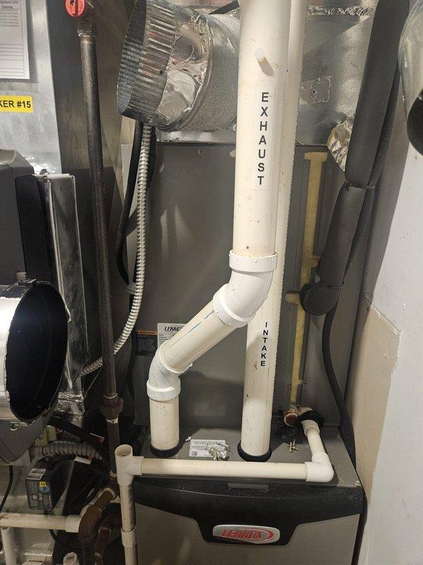 Responded to service call for temperature control issue reported by building management. Upon arrival, performed system diagnostic on Lennox furnace installation. Inspected exhaust and intake PVC venting, verified proper labeling and connections, checked expansion tank operation, and examined all ductwork connections. System found operating within normal parameters with no immediate mechanical failures detected.
