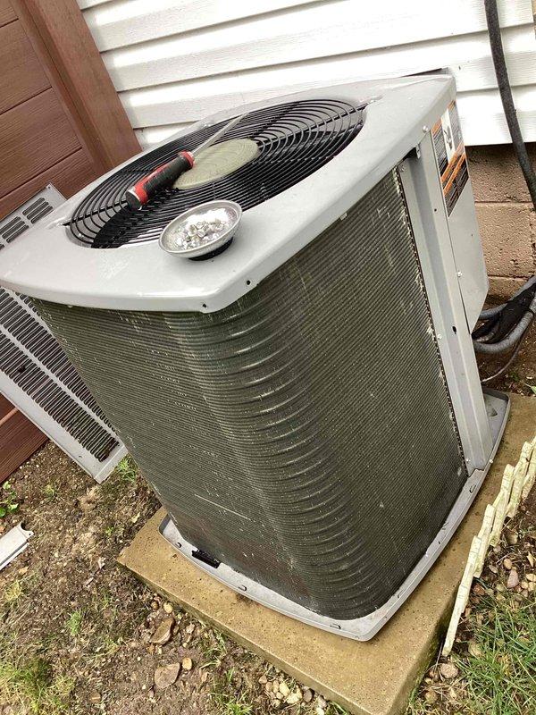 Completed routine maintenance on a 4-year-old Armstrong Air residential cooling system. Performed standard inspection of outdoor condensing unit, including evaluation of condenser coils which showed minor discoloration and potential algae buildup on aluminum fins. Verified fan assembly operation, checked electrical components including capacitor, and confirmed unit functionality. System operating within normal parameters following maintenance procedures.
