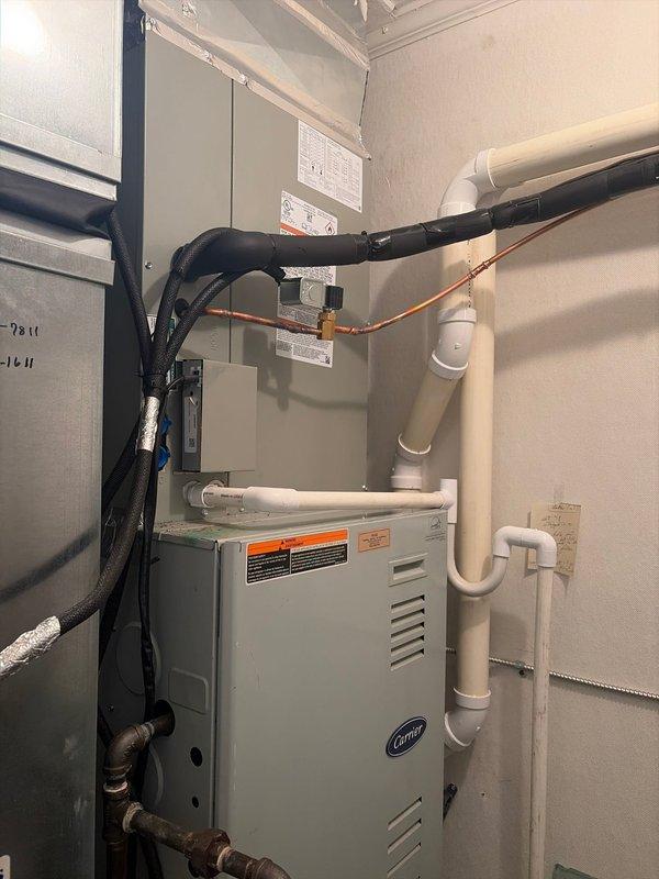 Completed commercial air conditioning and coil replacement at the facility. Removed existing HVAC equipment and installed new Carrier air handler unit in interior mechanical room with proper refrigerant line connections, PVC condensate drainage system, and electrical disconnect. Installed new outdoor condenser unit against exterior brick wall with appropriate electrical connections and refrigerant line set. All components were properly secured, insulated, and tested for operational performance per manufacturer specifications.
