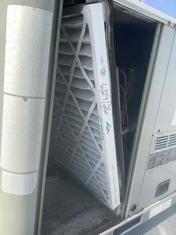 Performed filter replacement on commercial rooftop package HVAC unit. Customer-supplied 16x20 pleated air filter was installed in the unit housing, with filter properly seated and access panel secured upon completion.