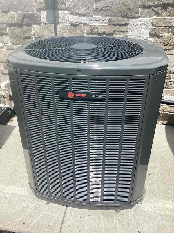Completed routine maintenance on 2-year-old Trane XTi residential air conditioning system. Performed standard cooling season inspection including temperature verification at 73°F, examined outdoor condenser unit condition, and confirmed proper system operation. Unit found in good working order with no deficiencies noted.