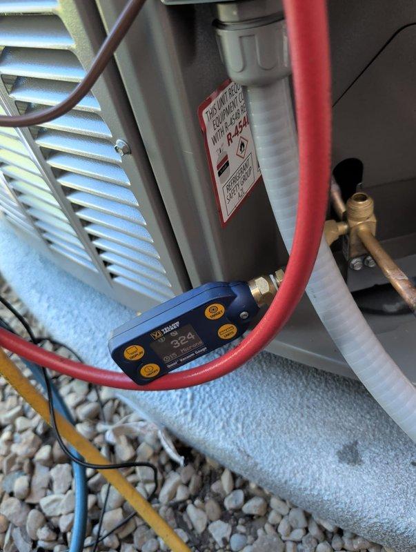 Completed new construction HVAC installation of Lennox air conditioning condenser unit. Unit was properly leveled on concrete pad, refrigerant lines were insulated and installed, and system was charged to manufacturer specifications at 264 PSI as verified with calibrated gauges. All connections were tested and secured, ensuring proper airflow through ventilation louvers and optimal system performance for the newly constructed space.