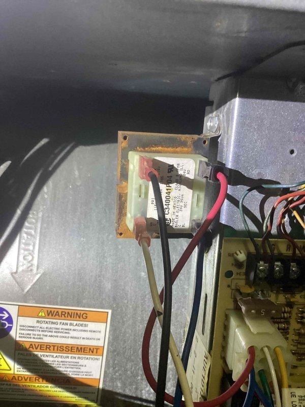 Responded to service call for non-functioning air conditioning system with reported indoor temperature of 80 degrees. Upon inspection, found American Standard furnace and Carrier air handler installation in basement utility area. Diagnosed electrical issue with transformer showing visible corrosion on mounting bracket and verified proper wiring connections to control components. Inspected ductwork, gas lines, and electrical conduit for proper installation and functionality. System restored to normal operation with proper cooling capacity achieved.