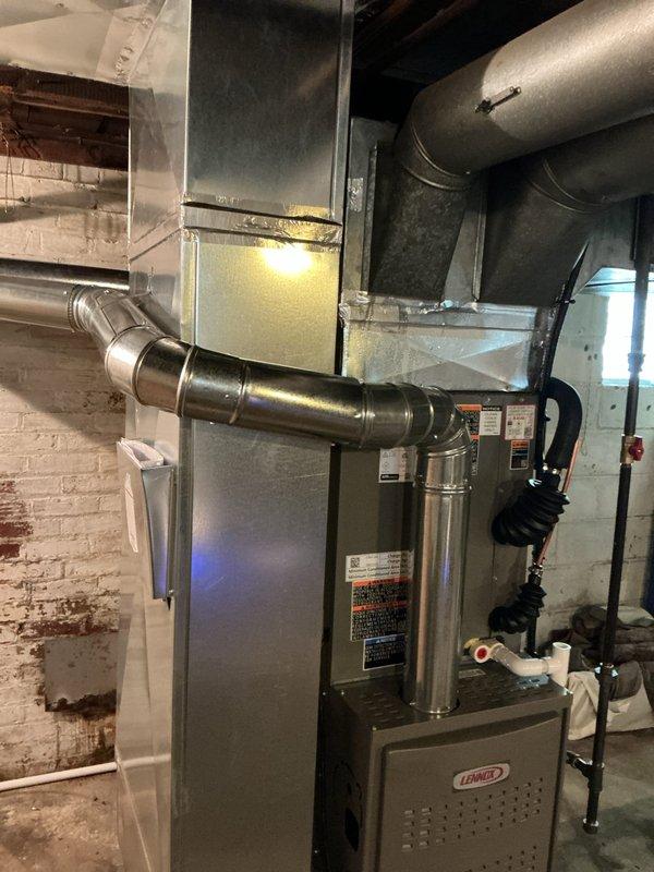 Completed full HVAC system retrofit in basement mechanical room, installing new Lennox furnace with complete ductwork modifications. Installed new refrigerant line set and connected all supply and return ductwork to existing distribution system. System tested and operational.