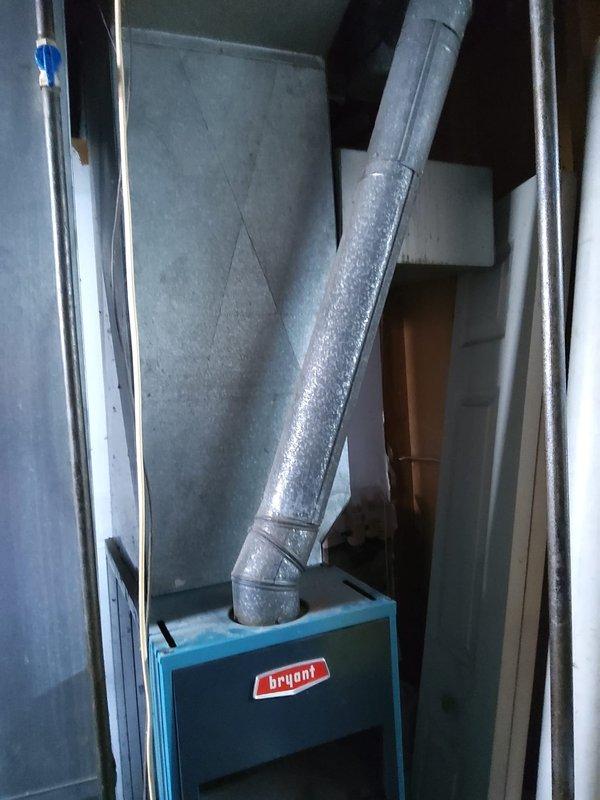 Completed furnace retrofit installation featuring a new Bryant high-efficiency unit in the basement utility area. Installed metallic supply ductwork and plenum connections at the furnace outlet, established proper electrical connections via wall-mounted junction box with appropriate conduit routing, and verified all ductwork seals and joints for optimal airflow distribution. System tested and confirmed operational with all safety controls functioning as designed.