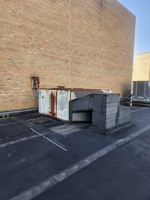 Responded to no cooling complaint on commercial rooftop unit. Upon arrival, inspected RTU and associated electrical components including rooftop disconnect switch. Documented equipment condition showing significant age and weathering on unit housing with visible rust and corrosion on exterior panels. Electrical disconnect examined with cover open, revealing three-blade fuse assembly and associated wiring connections in serviceable condition despite surface oxidation consistent with outdoor exposure. Customer advised to contact when technician en route for service completion.