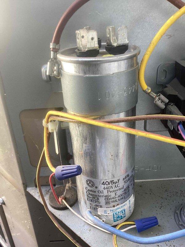 Completed spring maintenance on residential cooling system. Inspected and tested dual-run capacitor rated at 40/5μF 440V AC, verifying proper electrical connections and terminal integrity. Used Fluke digital multimeter to measure and confirm voltage readings at 305.8V, ensuring system operates within manufacturer specifications for optimal performance and reliability.