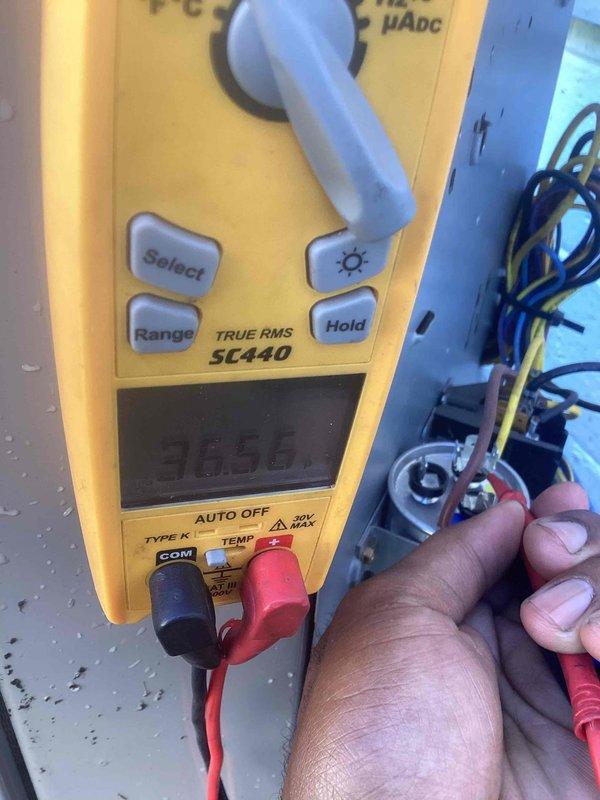 Completed spring maintenance on residential cooling system. Inspected and tested dual-run capacitor rated at 40/5μF 440V AC, verifying proper electrical connections and terminal integrity. Used Fluke digital multimeter to measure and confirm voltage readings at 305.8V, ensuring system operates within manufacturer specifications for optimal performance and reliability.