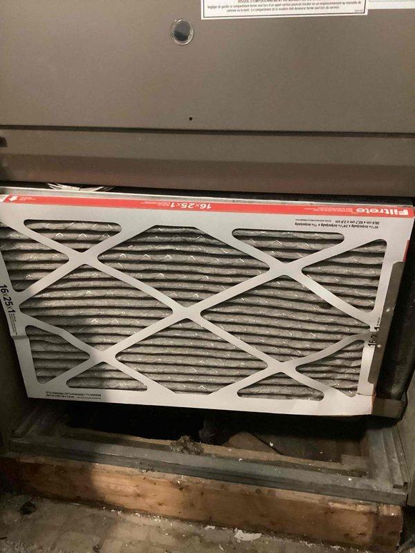 Performed comprehensive tune-up inspection on Goodman dual HVAC system including both furnace and air conditioning components. Inspected unit installed in recessed closet alcove, verified all manufacturer labels and safety warnings were intact, checked ductwork connections and condensate drain lines, and documented dirty air filter requiring replacement. System assessed and photographed for customer records, with on-site quote provided as requested.