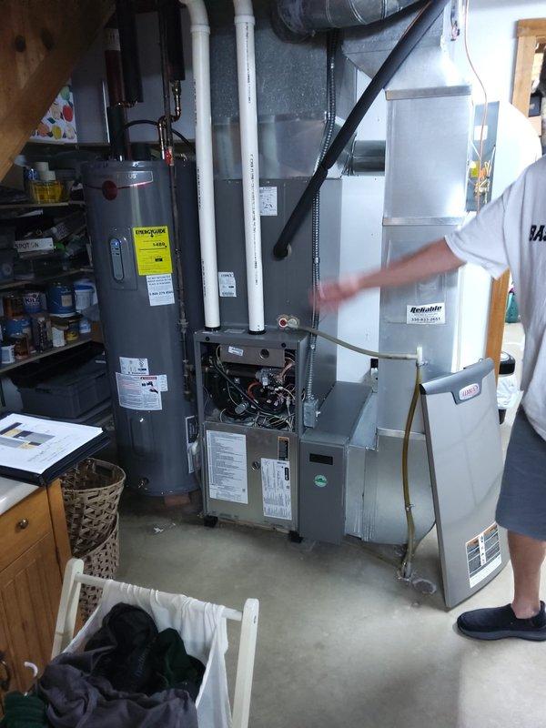 Completed AC retrofit installation at residential property. Installed new outdoor condensing unit with proper refrigerant line connections and electrical disconnect, positioned on rock bed with adequate clearance for airflow and service access. Verified indoor air handler compatibility with existing furnace system in basement mechanical room, confirmed all electrical connections, and ensured proper integration with current HVAC infrastructure.