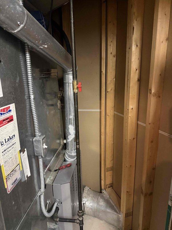 Performed follow-up dye search on residential air conditioning system after initial service visit. Located and inspected HVAC unit in basement mechanical room, checking all refrigerant connections, ductwork joints, and system components for evidence of UV dye indicating refrigerant leaks. Utilized digital manifold gauges to measure system pressures and temperatures, recording readings of 92.8 PSI low side, 242.8 PSI high side, with superheat and subcooling values within acceptable parameters. System operating normally with no active leaks detected at time of inspection.