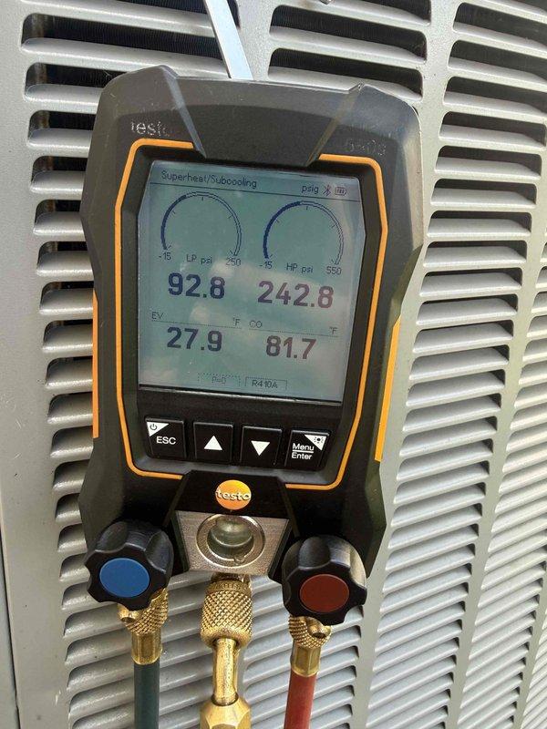 Performed follow-up dye search on residential air conditioning system after initial service visit. Located and inspected HVAC unit in basement mechanical room, checking all refrigerant connections, ductwork joints, and system components for evidence of UV dye indicating refrigerant leaks. Utilized digital manifold gauges to measure system pressures and temperatures, recording readings of 92.8 PSI low side, 242.8 PSI high side, with superheat and subcooling values within acceptable parameters. System operating normally with no active leaks detected at time of inspection.