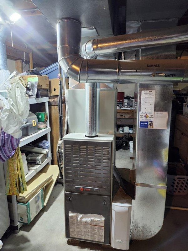 Completed installation of new air conditioning system in basement mechanical room. New AC unit was successfully integrated with existing Trane furnace system, including connection of refrigerant lines, condensate drainage, and electrical wiring to provide cooling capability to the residence. All ductwork connections were secured, system was tested for proper operation, and unit is functioning within manufacturer specifications.