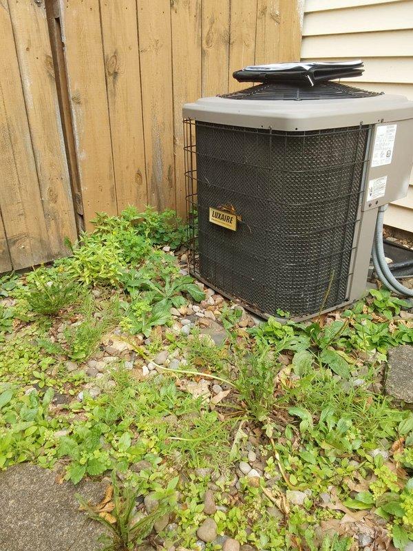 Completed comprehensive evaluation of existing HVAC system for AC retrofit replacement. Assessed indoor furnace unit located in attic space and outdoor Luxaire condenser unit positioned on building exterior. Documented current equipment configuration, including ductwork connections, refrigerant line routing, electrical conduit placement, and equipment mounting conditions. Noted outdoor unit situated on gravel pad with vegetation overgrowth requiring clearance prior to installation. Evaluated attic access, structural support requirements, and utility connections for new equipment installation. Provided detailed estimate for complete AC system replacement including removal of existing components, installation of new indoor and outdoor units, refrigerant line set, electrical connections, and system startup procedures.