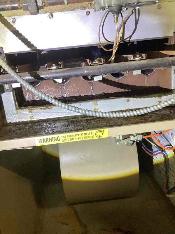 Performed comprehensive air conditioning tune-up service including removal and cleaning of evaporator coil which showed moderate accumulation of dust and debris between fins. Inspected internal components of air handler unit, verified proper drainage system operation, and confirmed all electrical connections and wiring were secure and functioning correctly.