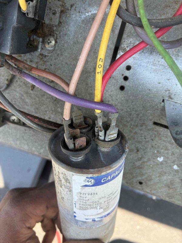 # Commercial A/C System Restoration

Responded to no-cooling call at commercial salon facility with reported high humidity levels causing moisture accumulation on furniture. Upon arrival, found system completely inoperative. Performed diagnostic testing on electrical components and identified failed capacitor as root cause of system failure. Measured electrical values using clamp meter to confirm capacitor degradation and verify proper amperage draw requirements for compressor operation.

Removed defective capacitor showing signs of age, corrosion, and electrical failure at terminal connections. Installed new GE replacement capacitor with appropriate microfarad and voltage ratings per manufacturer specifications. Reconnected all electrical leads to proper terminals, ensuring secure connections. Cycled system through complete startup sequence and verified normal operation. Confirmed compressor engaging properly and unit cooling effectively. System restored to full operational status, re