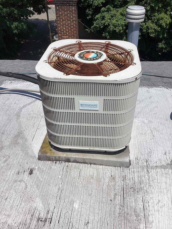 Responded to service call for non-operational rooftop air conditioning unit. Inspected Frigidaire commercial condenser and electrical panel, documenting capacitor dated 7/9/20 and all electrical connections including contactors, relays, and control board. Diagnosed system failure, performed necessary repairs to restore cooling operation to affected unit.