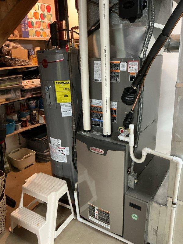 Completed AC retrofit installation at residential property. Installed new Lennox air conditioning condenser unit on exterior pad with proper electrical disconnect and refrigerant line connections. Replaced indoor evaporator coil to match new outdoor unit, integrated with existing Lennox furnace system in basement mechanical room. Verified all refrigerant lines, electrical connections, and condensate drainage are properly installed and functioning. System tested and operational.