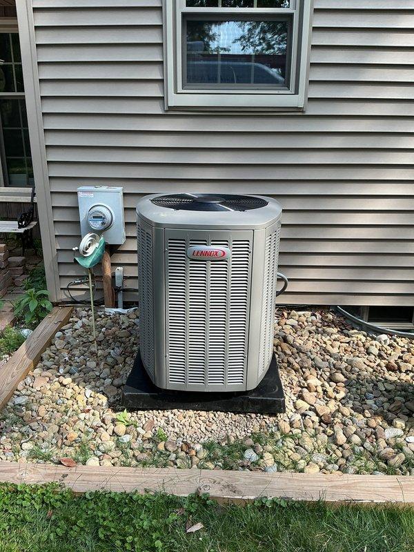 Completed AC retrofit installation at residential property. Installed new Lennox air conditioning condenser unit on exterior pad with proper electrical disconnect and refrigerant line connections. Replaced indoor evaporator coil to match new outdoor unit, integrated with existing Lennox furnace system in basement mechanical room. Verified all refrigerant lines, electrical connections, and condensate drainage are properly installed and functioning. System tested and operational.