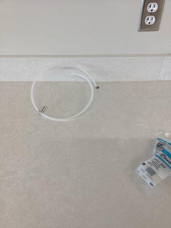 Completed appliance piping installation in new construction building. Installed flexible supply lines with compression fittings and integrated shut-off valve with wall-mounted access panel for future serviceability. All connections tested and verified leak-free, with proper access maintained for appliance hookups.