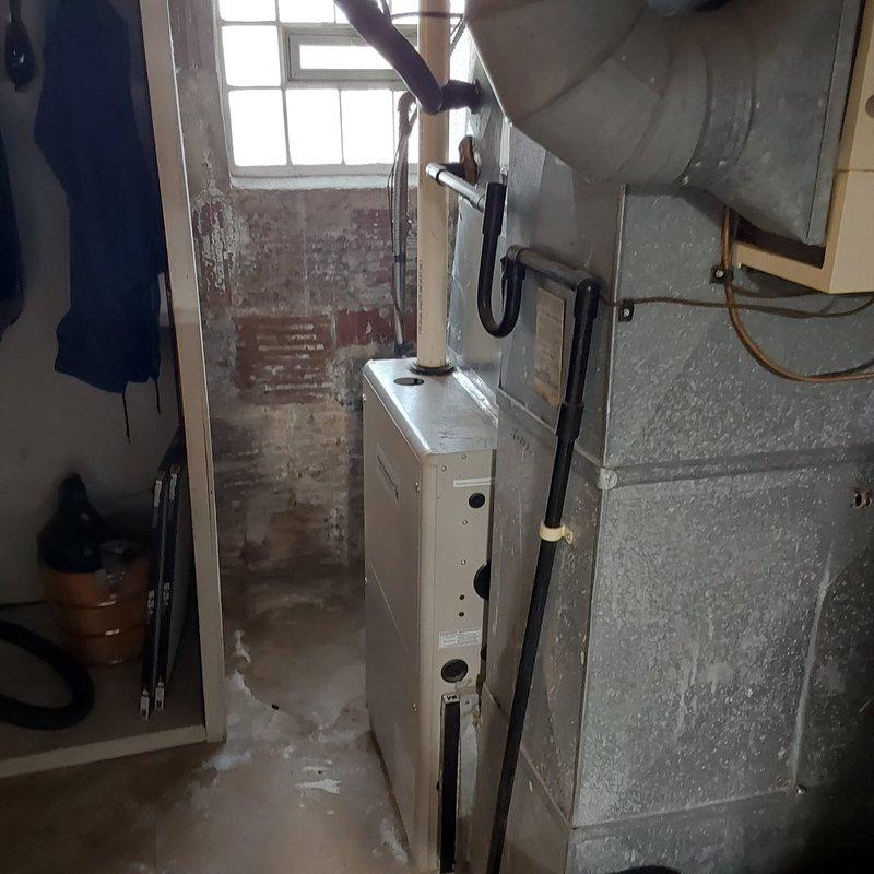 Completed furnace retrofit installation in basement mechanical room, replacing existing heating equipment with new Kensington unit. Connected ductwork, verified proper ventilation connections, and ensured all mechanical systems were properly integrated with existing HVAC infrastructure.