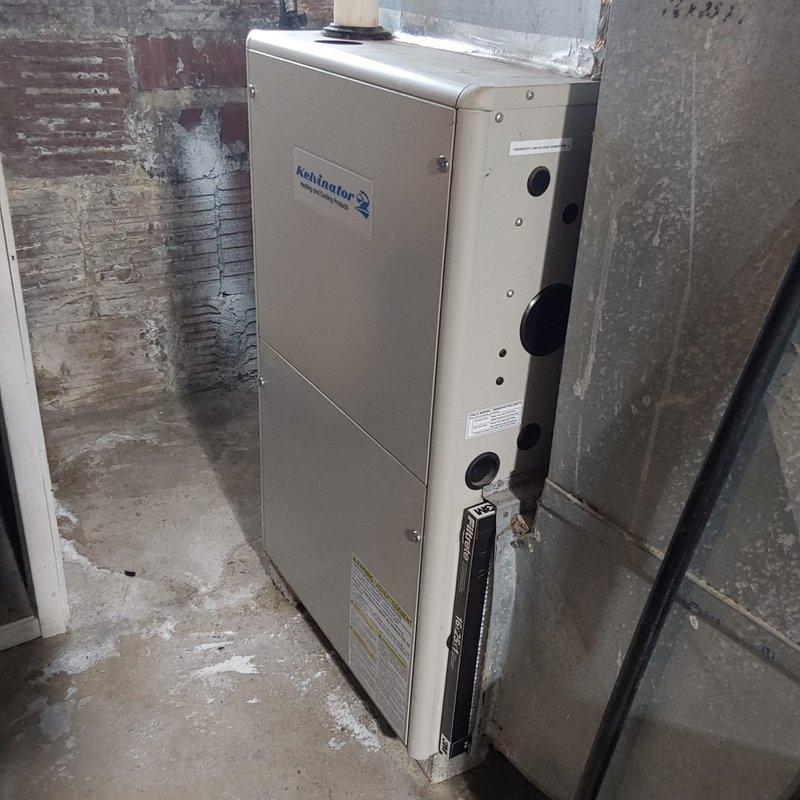 Completed furnace retrofit installation in basement mechanical room, replacing existing heating equipment with new Kensington unit. Connected ductwork, verified proper ventilation connections, and ensured all mechanical systems were properly integrated with existing HVAC infrastructure.
