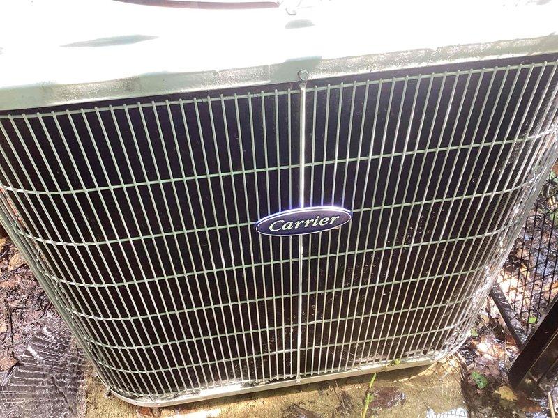 Completed scheduled commercial cooling maintenance visit. Inspected exterior Carrier condenser unit, noting normal weathering and operational condition of protective grille and components. Verified indoor horizontal furnace system, ductwork connections, and condensate drainage lines for proper operation and secure installation. All equipment functioning within normal parameters.