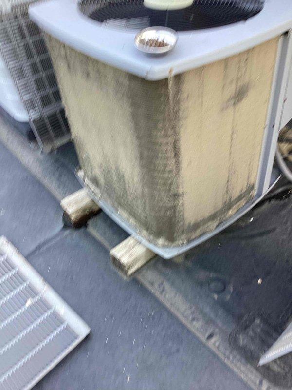 Completed scheduled spring maintenance on rooftop commercial HVAC condenser unit. Performed comprehensive system inspection, verified operating temperatures with digital thermometer showing 65.5°F reading at air handler, cleaned condenser coils and cabinet exterior, checked electrical connections and capacitor, and confirmed proper unit operation. All components found to be functioning within normal parameters with no immediate repairs required.