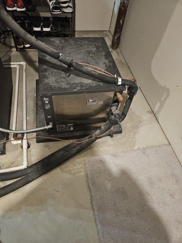 Performed comprehensive system evaluation on 19-year-old Advantage geothermal heat pump unit as requested second opinion following previous contractor assessment. Conducted thorough inspection of ground loop connections, refrigerant line sets with identification tags, air handler cabinet, and associated drainage components in basement installation. Documented current system condition with photographic evidence showing refrigerant piping configuration, insulated line sets, and overall equipment status to provide customer with informed assessment of repair versus replacement options.