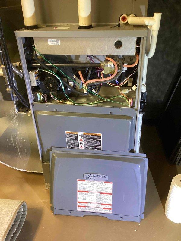 Replaced failed blower motor and control module on Armstrong Air furnace unit. Removed access panels, disconnected existing motor assembly from electrical connections and housing, installed new blower motor with mounting brackets, and replaced control module to restore proper airflow and system operation.