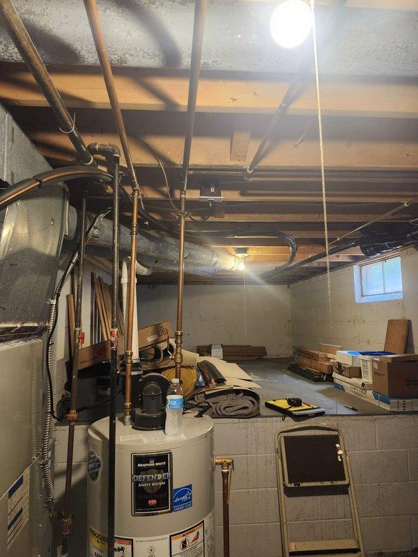 Conducted pre-installation site assessment and measurements for complete HVAC system replacement in residential basement location. Evaluated existing mechanical room layout, documented current equipment placement including water heater positioning, and assessed utility infrastructure including copper plumbing lines, electrical conduits, and available mounting surfaces. Measured ductwork pathways, ceiling clearances with exposed joists, and determined optimal equipment placement for new system installation. Photographed existing conditions showing concrete block walls, basement window location, and current HVAC equipment configuration with associated ductwork and control panel. Verified electrical panel accessibility and confirmed adequate space for new system components. Site preparation measurements completed to ensure proper sizing and efficient installation workflow scheduled for upcoming installation date.