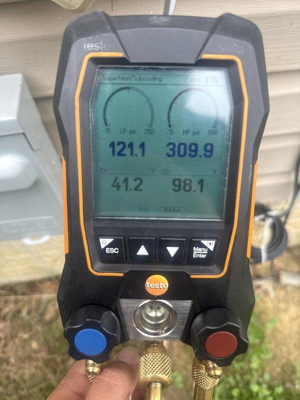 Responded to service call for loud noise and power fluctuation issues affecting HVAC system and building electrical. Upon arrival, performed diagnostic assessment of outdoor condensing unit and found electrical anomalies requiring immediate attention. Inspected internal wiring compartment, checked all electrical connections, wire nuts, and control wiring for signs of arcing, loose connections, or component failure. Utilized digital manifold gauges to verify system pressures and performance parameters, recording readings of 121.1 psi low-side, 309.9 psi high-side, with superheat at 41.2°F and subcooling at 98.1°F. Addressed electrical concerns that were causing power disruptions to prevent further system damage and restore safe operation. Unit tested and returned to normal operating condition.