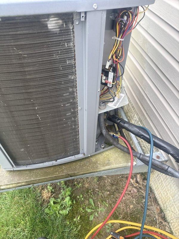 Responded to service call for loud noise and power fluctuation issues affecting HVAC system and building electrical. Upon arrival, performed diagnostic assessment of outdoor condensing unit and found electrical anomalies requiring immediate attention. Inspected internal wiring compartment, checked all electrical connections, wire nuts, and control wiring for signs of arcing, loose connections, or component failure. Utilized digital manifold gauges to verify system pressures and performance parameters, recording readings of 121.1 psi low-side, 309.9 psi high-side, with superheat at 41.2°F and subcooling at 98.1°F. Addressed electrical concerns that were causing power disruptions to prevent further system damage and restore safe operation. Unit tested and returned to normal operating condition.