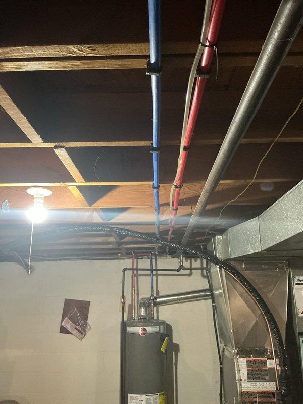 Responded to service call for water pressure adjustment and potential kitchen sink leak evaluation. Inspected plumbing system infrastructure including PEX piping, water heater connections, and supply lines in mechanical room. Assessed water pressure settings and documented existing plumbing configuration for follow-up diagnostic work on reported kitchen sink leak.