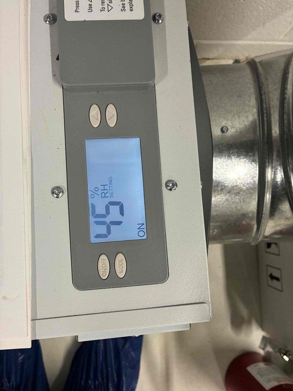 Completed annual cooling maintenance on three 13-year-old air conditioning units. Inspected and evaluated dehumidifier system, noting humidity setpoint configuration at 54% RH with unit operational. Examined condensate drainage system including PVC drain lines and verified proper water removal from equipment.